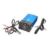 Red/black car battery cables, a 12V DC adapter and owner's manual are included.